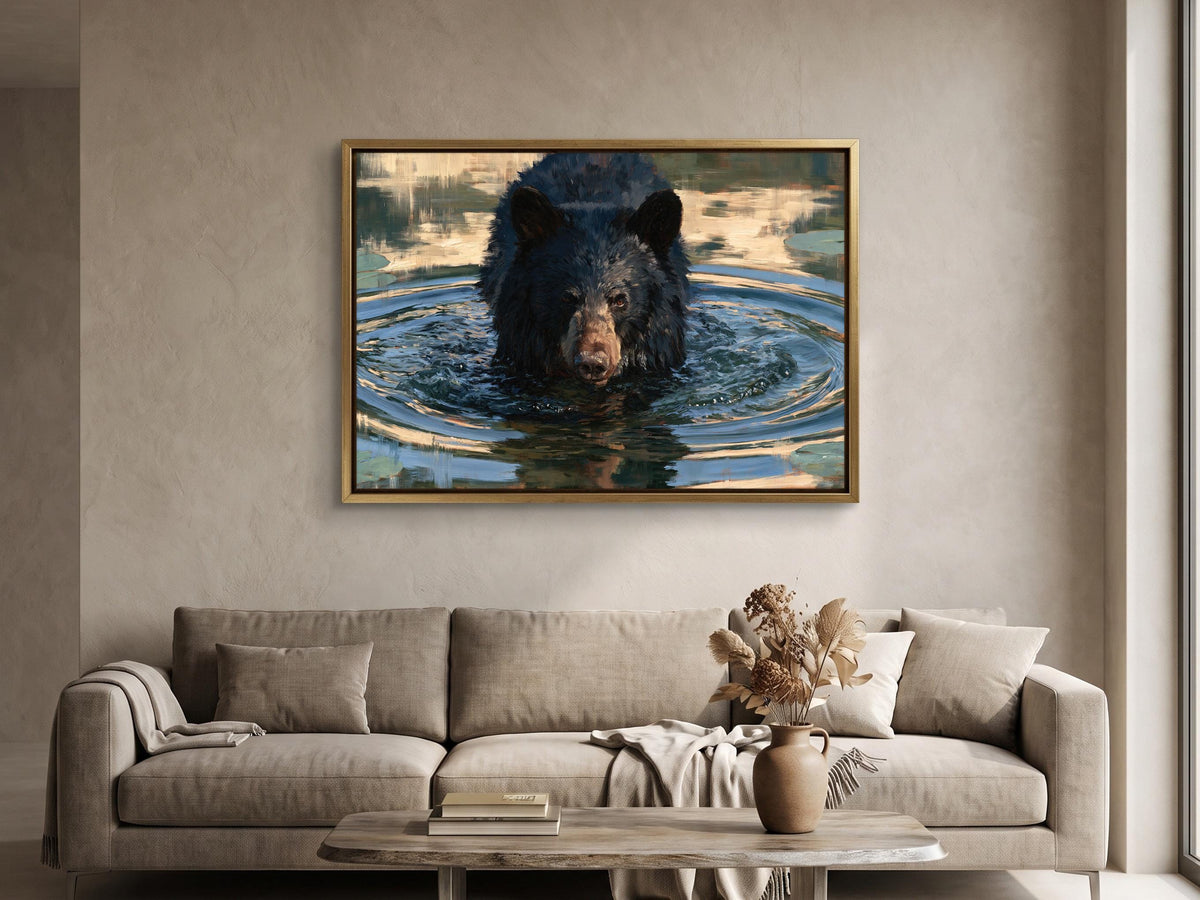 a large framed painting of a black bear swimming in water, hanging on a wall above a beige sofa in a living room.