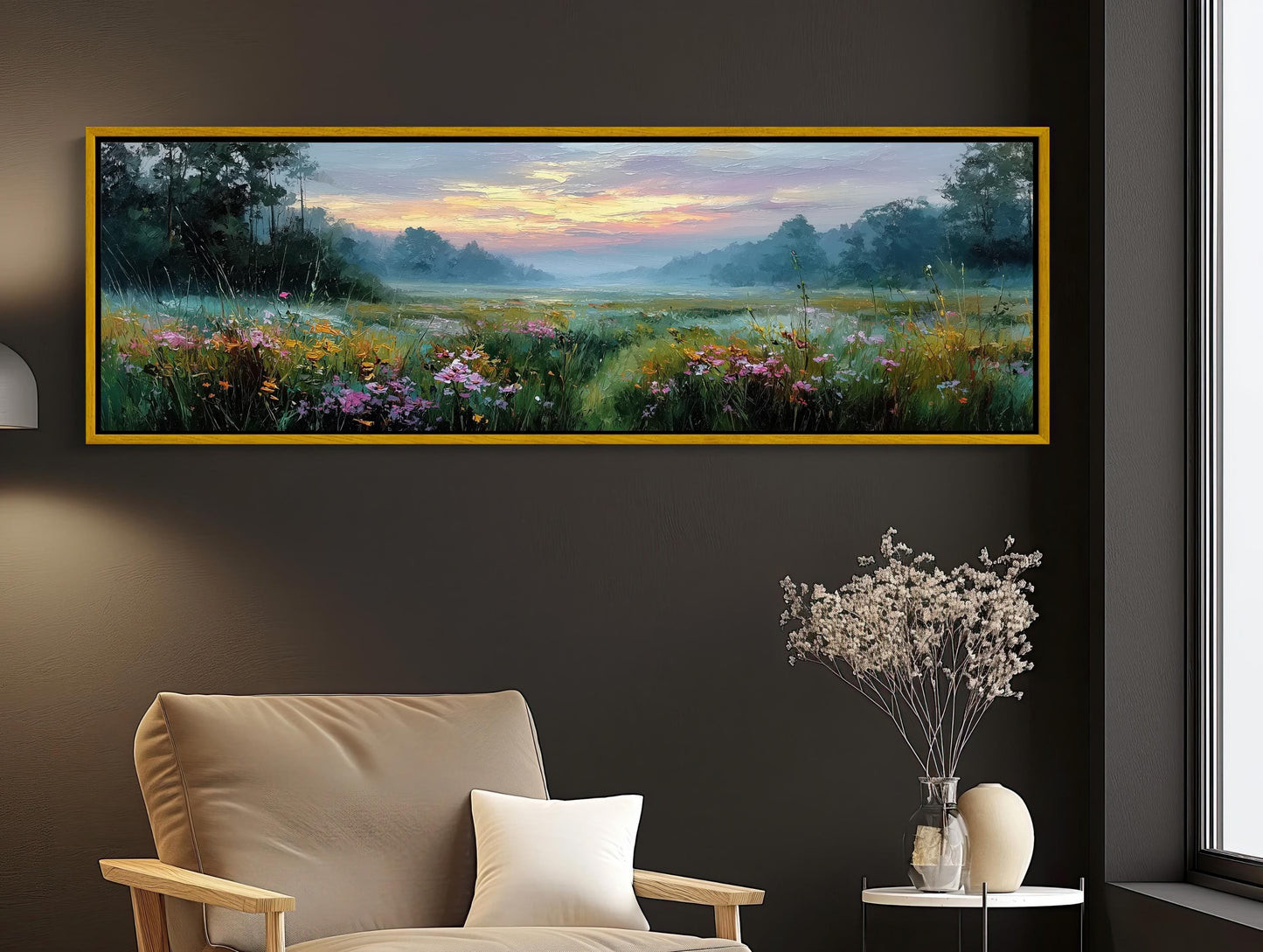 a large painting of a field with flowers hanging on a wall above a beige armchair in a living room setting.