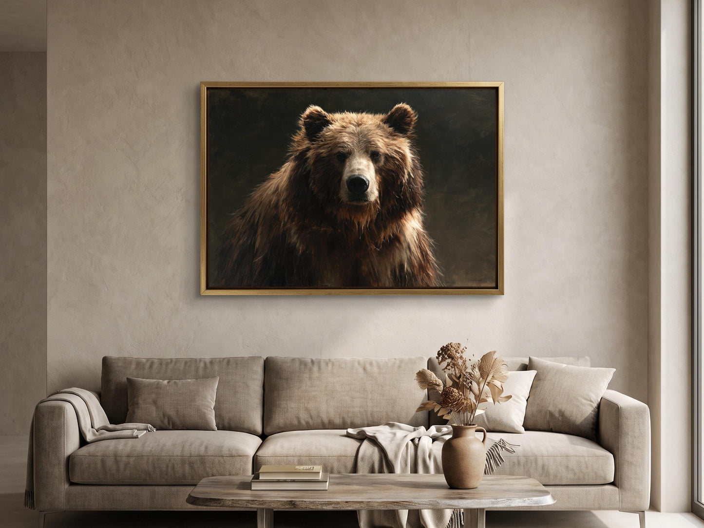 a large brown bear in a framed painting hanging on a wall above a beige sofa in a living room.