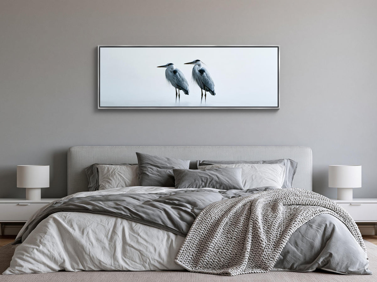 Two herons in mist canvas wall art, bedroom with a large bed, a gray and white blanket, and a framed photograph of two birds