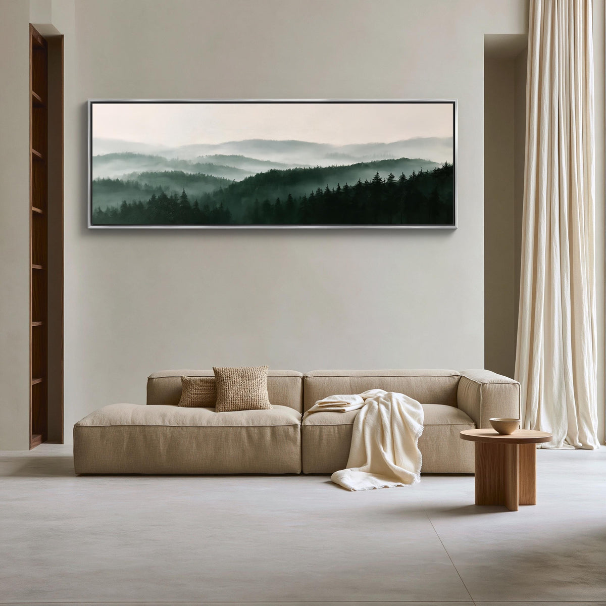 Misty pine forest ridges canvas wall art, large, beige sectional sofa with a wooden coffee table in front of it, set against