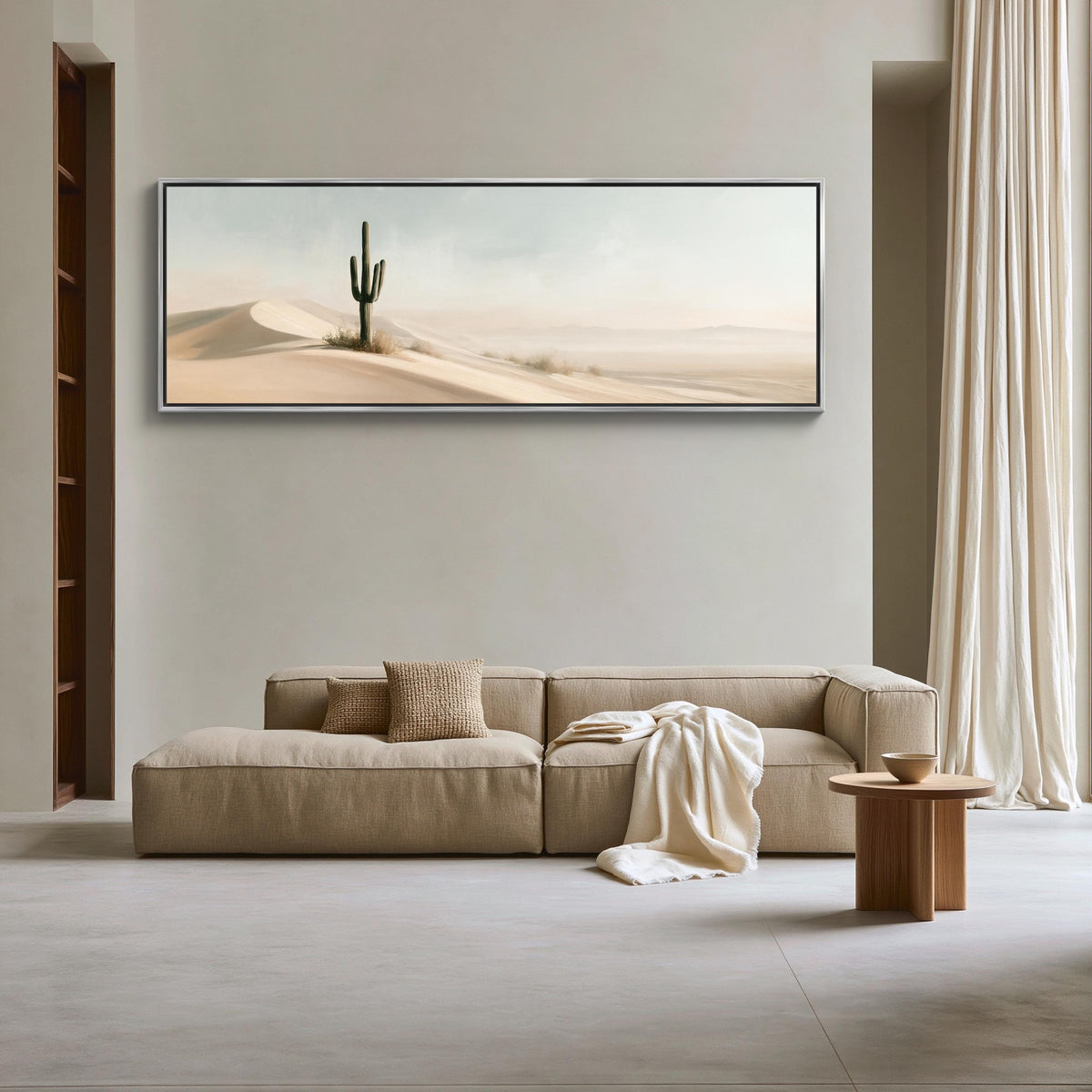 Lone saguaro on sand dunes canvas wall art, large, beige sectional sofa with a wooden coffee table in front of it, set