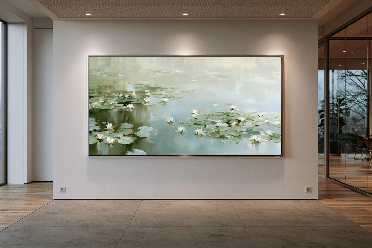 a large painting of water lilies hanging on a white wall in a room with a wooden floor.