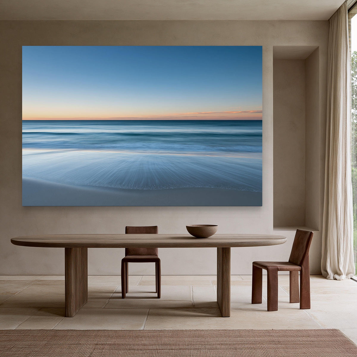 Ocean horizon at dusk canvas wall art, serene beach scene with a large painting of the ocean and sky hanging on the wall
