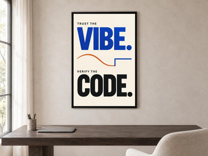 a poster with the text "Trust the VIBE. VERIFY the CODE." displayed on a wall above a wooden desk with a laptop and a chair.