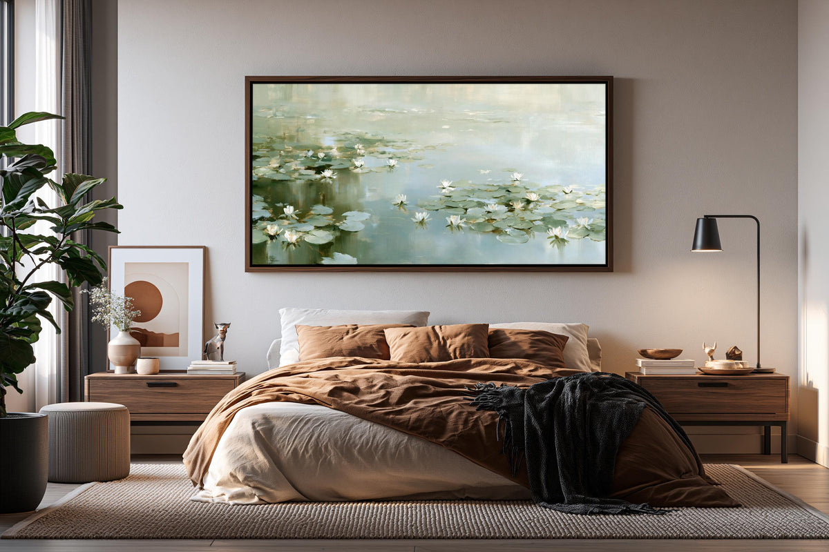 a serene bedroom scene with a large bed, a wooden nightstand, and a framed painting of water lilies on the wall.