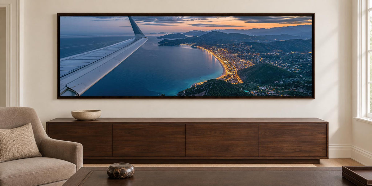 A large, high-resolution image of an airplane wing is displayed on the wall above a wooden entertainment center in a living room.