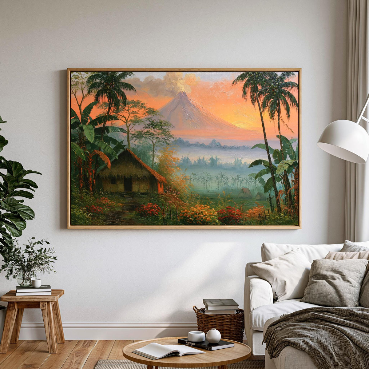 a large painting of a tropical landscape with a mountain in the background, surrounded by lush greenery and palm trees. The painting is hung on a white wall above a couch in a living room setting.