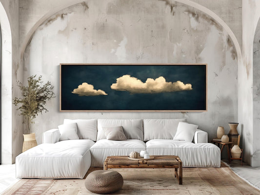 a living room with a white couch and a painting on the wall