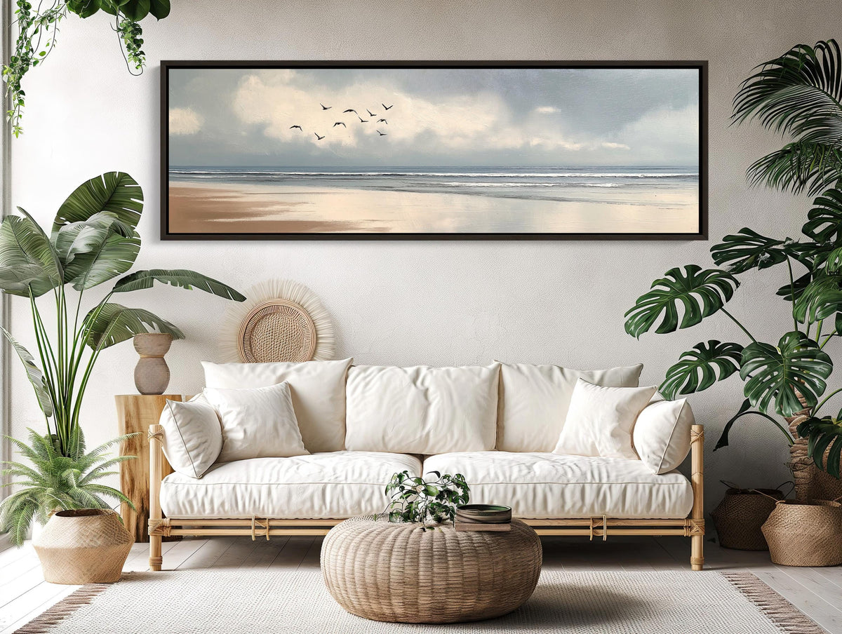 Birds over calm beach canvas wall art, living room with a couch, potted plants and a painting on the wall