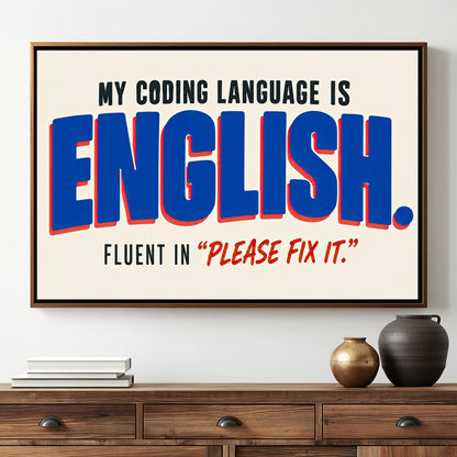 a framed poster with the text "MY CODING LANGUAGE IS ENGLISH. FLUENT IN "PLEASE FIX IT""".