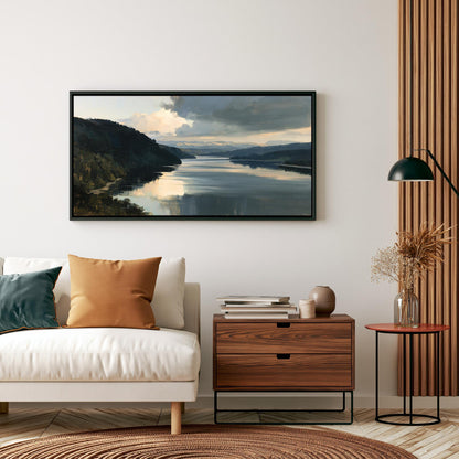 a living room with a white sofa, a wooden side table, and a framed landscape painting hanging on the wall above the sofa.