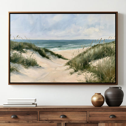 a large painting of a beach scene hanging on a wall above a wooden dresser. The painting depicts a sandy beach with dunes, grass, and the ocean in the background. The dresser has a stack of books and two decorative vases on it.