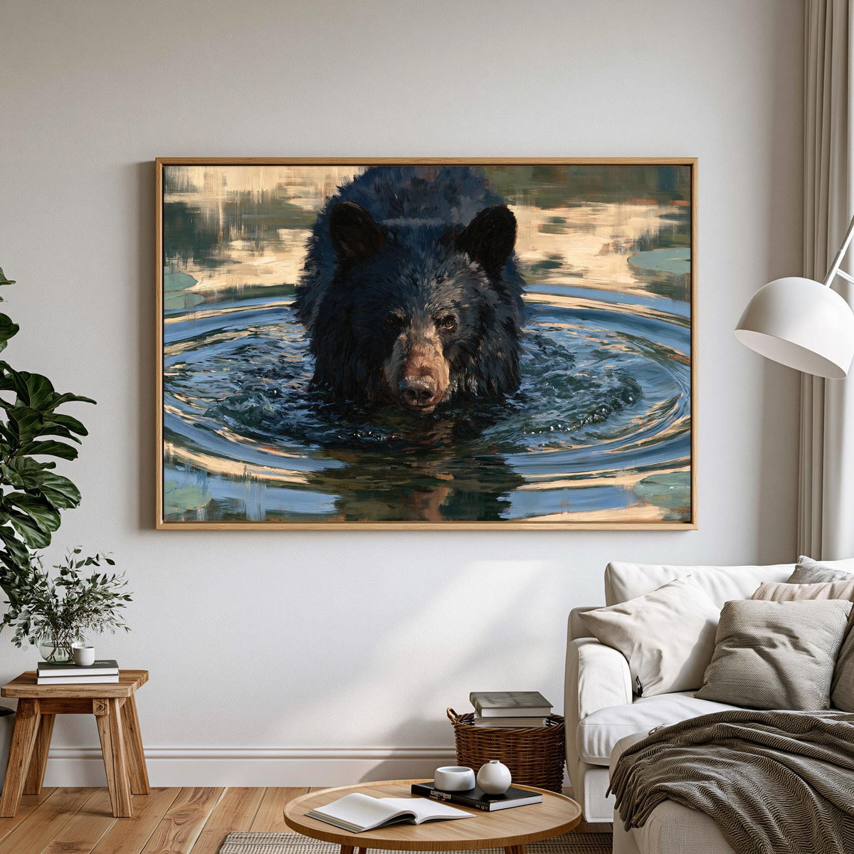 A large framed painting of a black bear swimming in water hangs on a white wall in a living room.