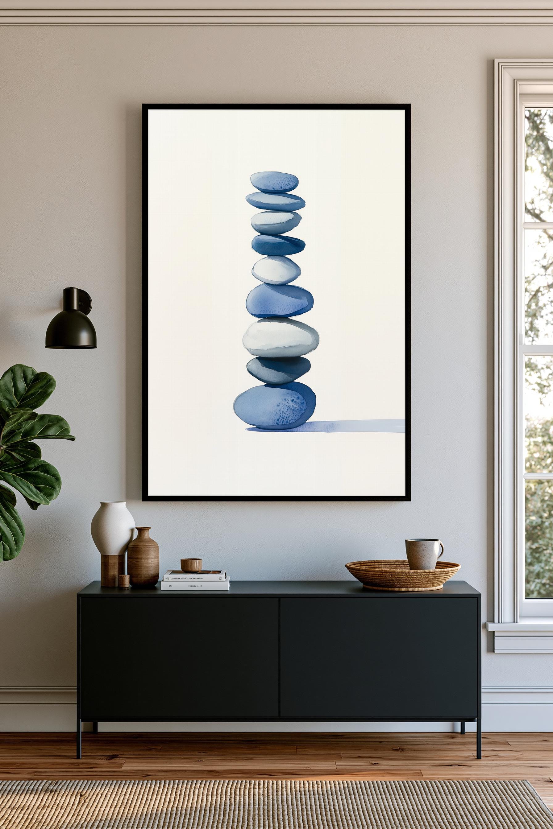a black cabinet with a framed picture of blue and white stones hanging on the wall above it.