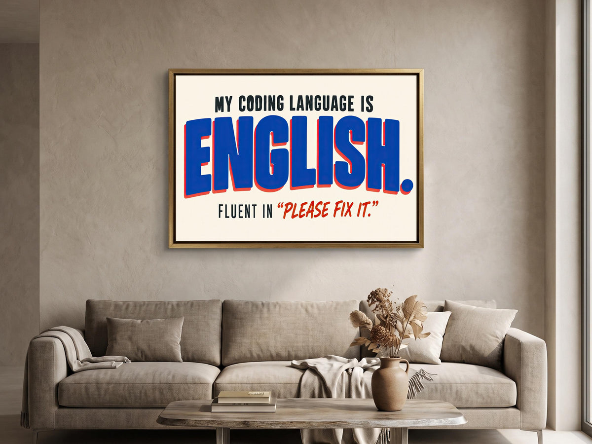 a framed statement on a wall, which reads "MY CODING LANGUAGE IS ENGLISH. FLUENT IN 'PLEASE Fix It'".