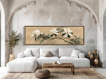 a modern living room with a large white sofa, a wooden coffee table, and a framed painting of white flowers on the wall above the sofa.