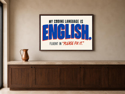 a framed poster with the text "MY CODING LANGUAGE IS ENGLISH. FLUENT IN "PLEASE Fix It"".