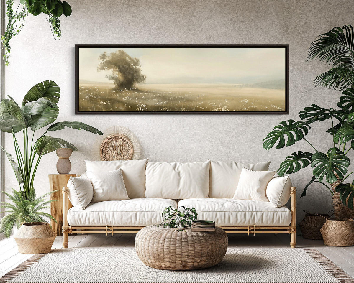 Lone tree vintage meadow canvas wall art, living room with a couch, potted plants and a painting on the wall