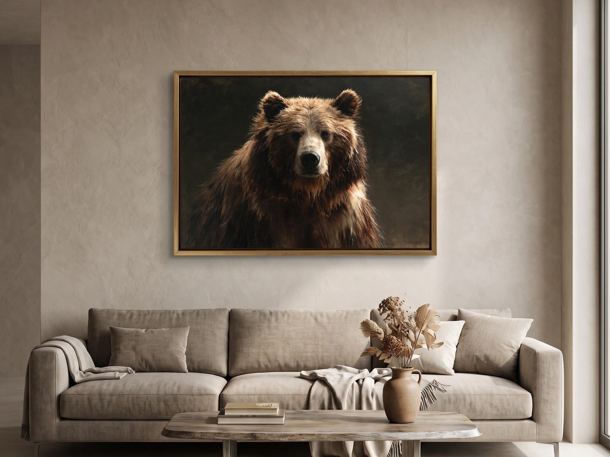 a large brown bear in a framed painting hanging on a wall above a beige sofa in a living room.