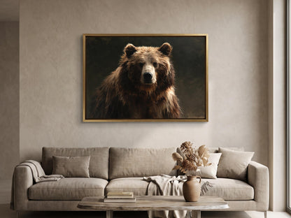 a large brown bear in a framed painting hanging on a wall above a beige sofa in a living room.