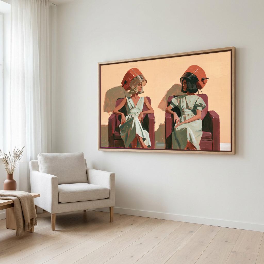 a large framed painting of two women sitting in chairs, with one woman wearing a green dress and the other wearing a red dress. The painting is hanging on a white wall in a room with a beige armchair and a wooden side table.