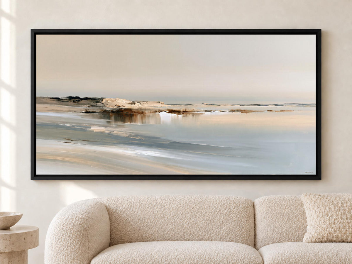 a large, framed painting of a serene landscape depicting a beach with a calm body of water in the background.