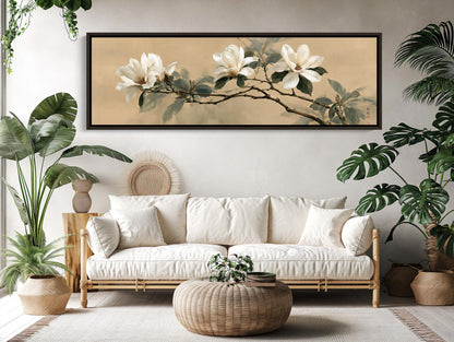 a living room with a large white sofa, a wicker coffee table, and a framed painting of white flowers on the wall above the sofa.