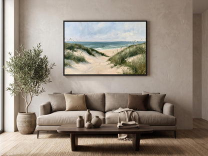 a serene living room with a large painting of a beach scene hanging on the wall above a beige sofa. The sofa is adorned with two throw pillows and a blanket, creating a cozy and inviting atmosphere. A coffee table is placed in front of the sofa, and a potted plant is situated next to it, adding a touch of greenery to the space. The overall design of the room is minimalist and harmonious, with the painting serving as the focal point.
