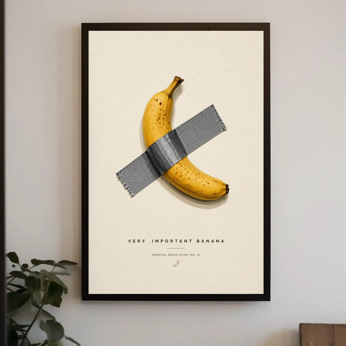 The image is a framed poster with a banana taped to a piece of tape, accompanied by the text "Very Important Banana" and "Archive Study No. 1".