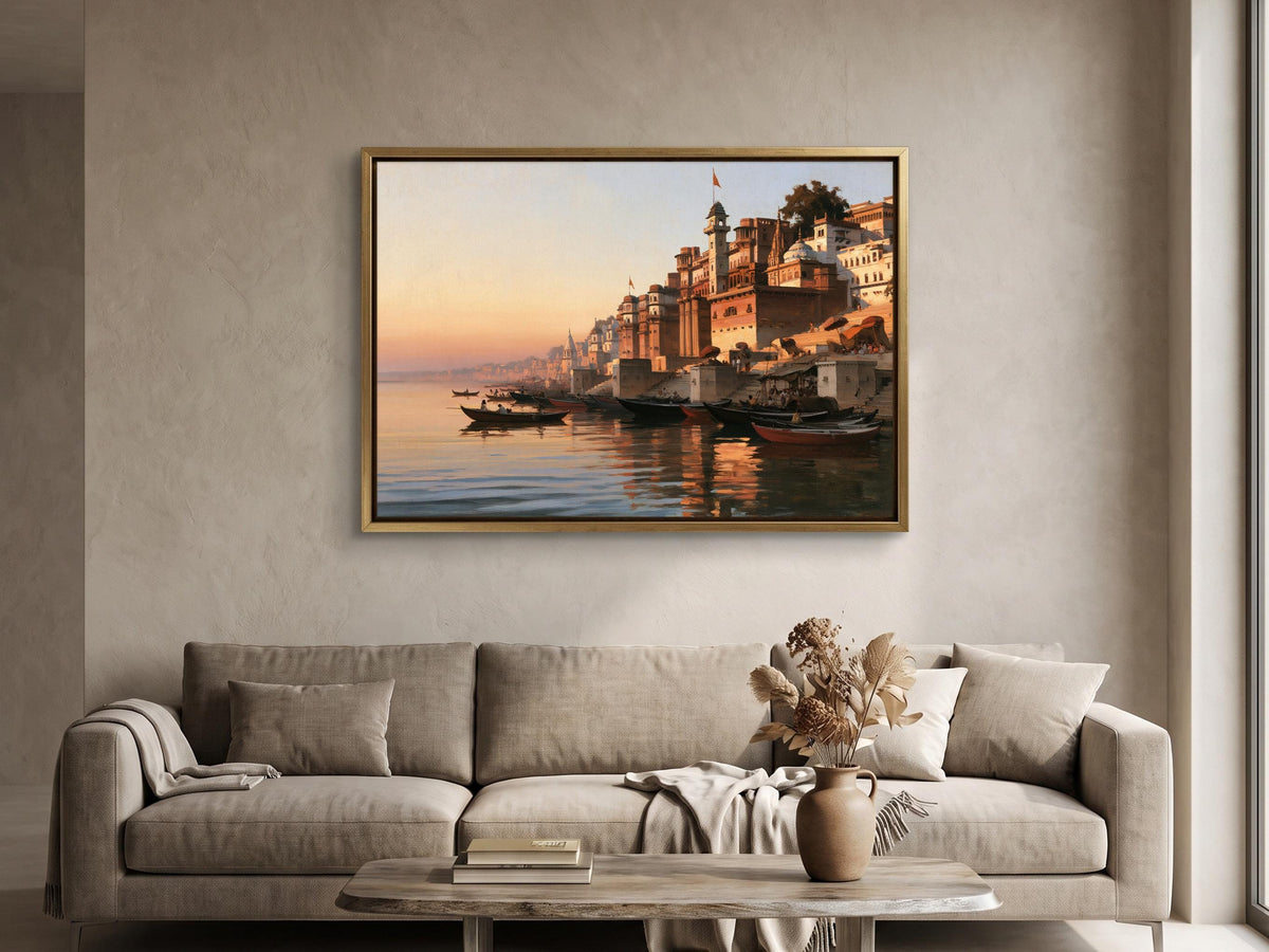a large framed painting of a serene waterfront scene with boats and buildings reflected in the water, hanging on a wall above a beige sofa in a living room.