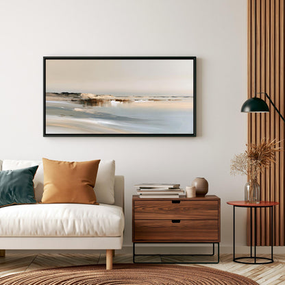 a living room with a white sofa, a wooden side table, and a framed landscape painting hanging on the wall above the sofa.