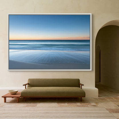 Ocean horizon at dusk canvas wall art, large, framed picture of a serene beach scene with a calm ocean and a sandy beach