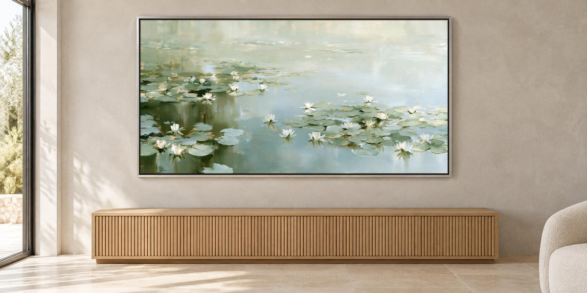 a large painting of water lilies hanging on a wall in a room with a wooden cabinet below it.