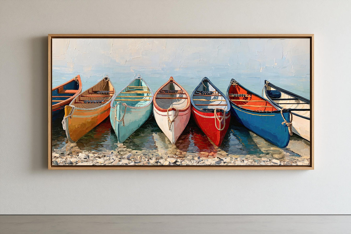 A framed painting depicting a row of colorful canoes lined up on a rocky shore, with a serene body of water in the background.