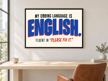 a framed poster with the text "MY CODING LANGUAGE IS ENGLISH. FLUENT IN "PLEASE FIX IT"".