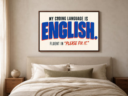 a bedroom with a bed and a framed poster on the wall that reads "MY CODING LANGUAGE IS ENGLISH. FLUENT IN "PLEASE FIX IT"".