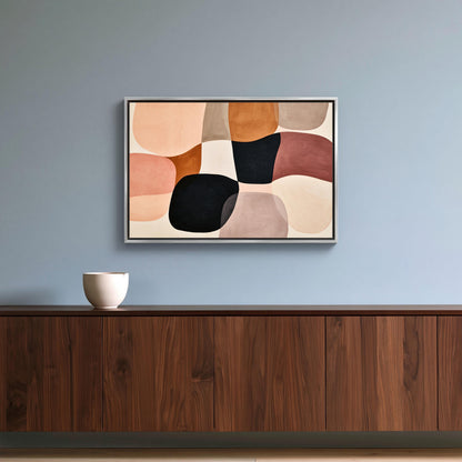 Blush organic shapes abstract canvas wall art, wooden cabinet with a white bowl on top, and above it is a framed abstract