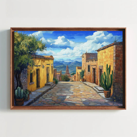The image is a painting depicting a picturesque street in a desert town, with colorful buildings, cacti, and a distant view of mountains under a blue sky with clouds.