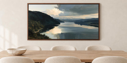 a large painting of a serene landscape with a calm lake and mountains in the background, hanging on a wall above a wooden dining table with four white chairs.