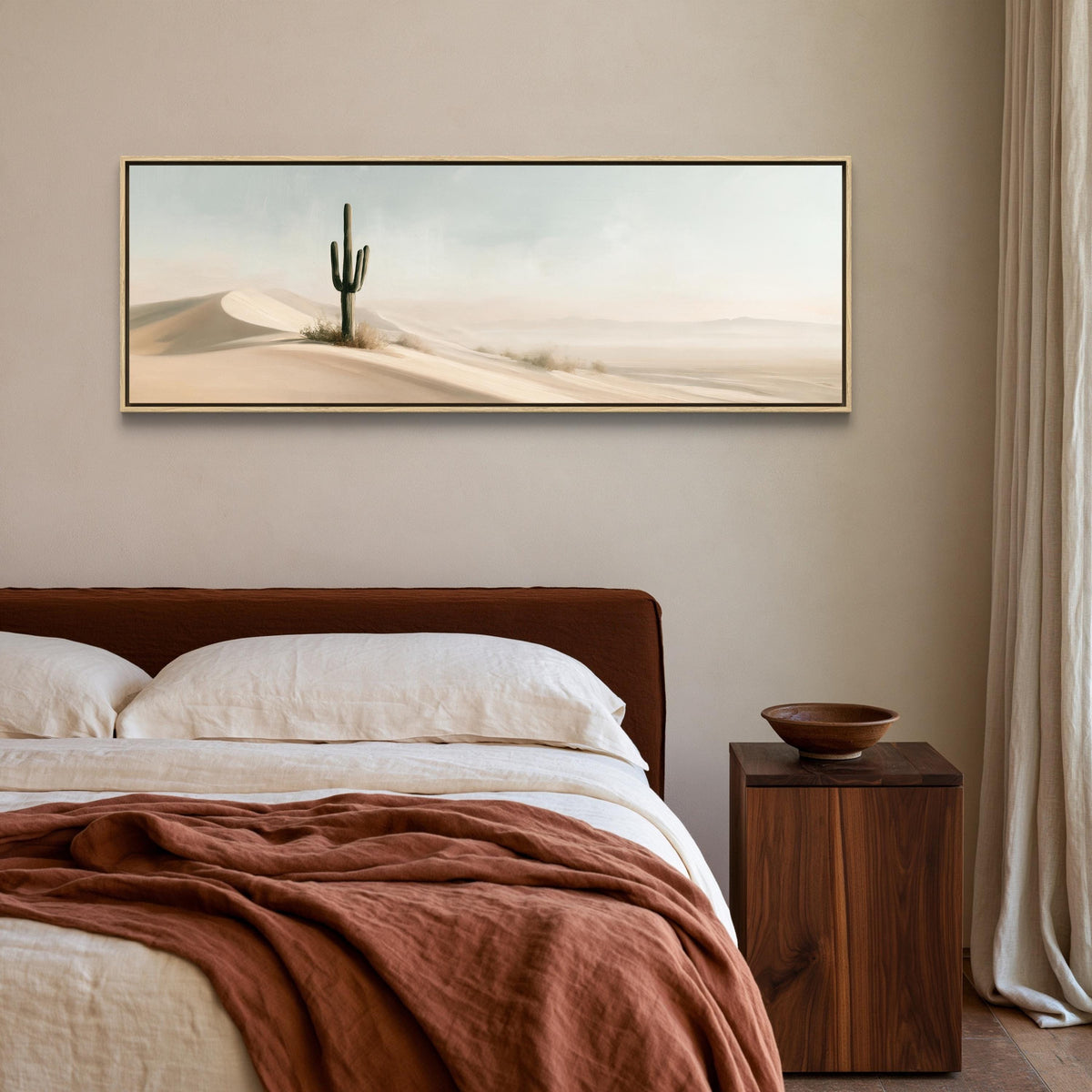 Lone saguaro on sand dunes canvas wall art, bedroom with a large bed, a wooden nightstand, and a framed landscape painting