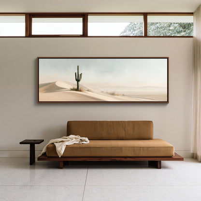 Lone saguaro on sand dunes canvas wall art, large desert landscape painting hanging on a wall above a brown sofa in a
