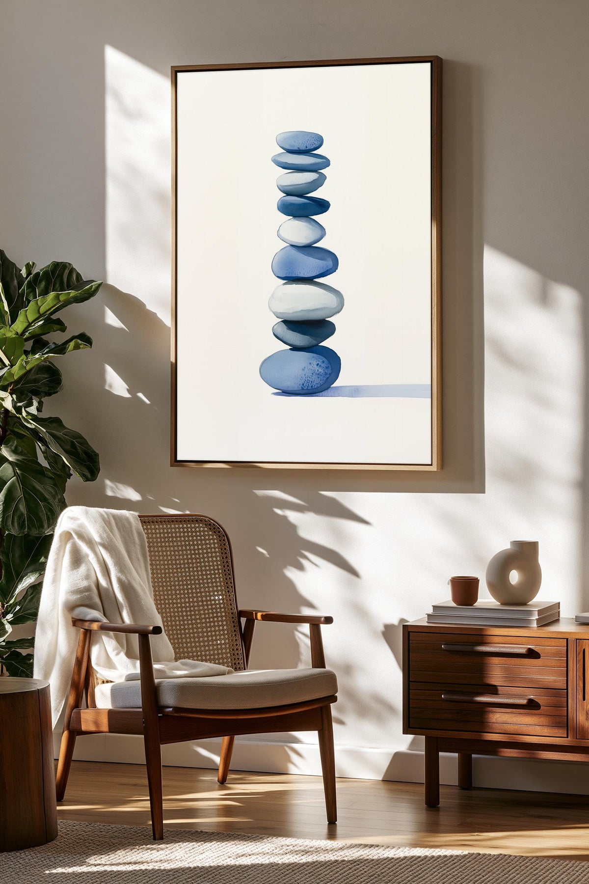 a cozy living room with a wooden chair, a wooden side table, and a framed artwork of blue and white stones hanging on the wall.