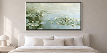 a serene bedroom scene with a large framed painting of lily pads and water lilies hanging above a bed with white bedding.