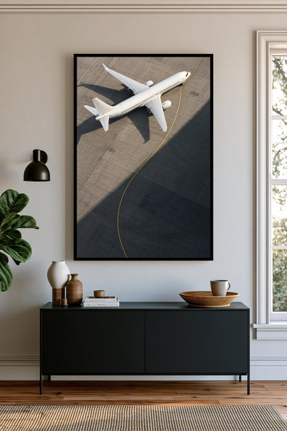 a large black cabinet with a wooden tray on top, and a framed photograph of a white airplane on the wall above it.