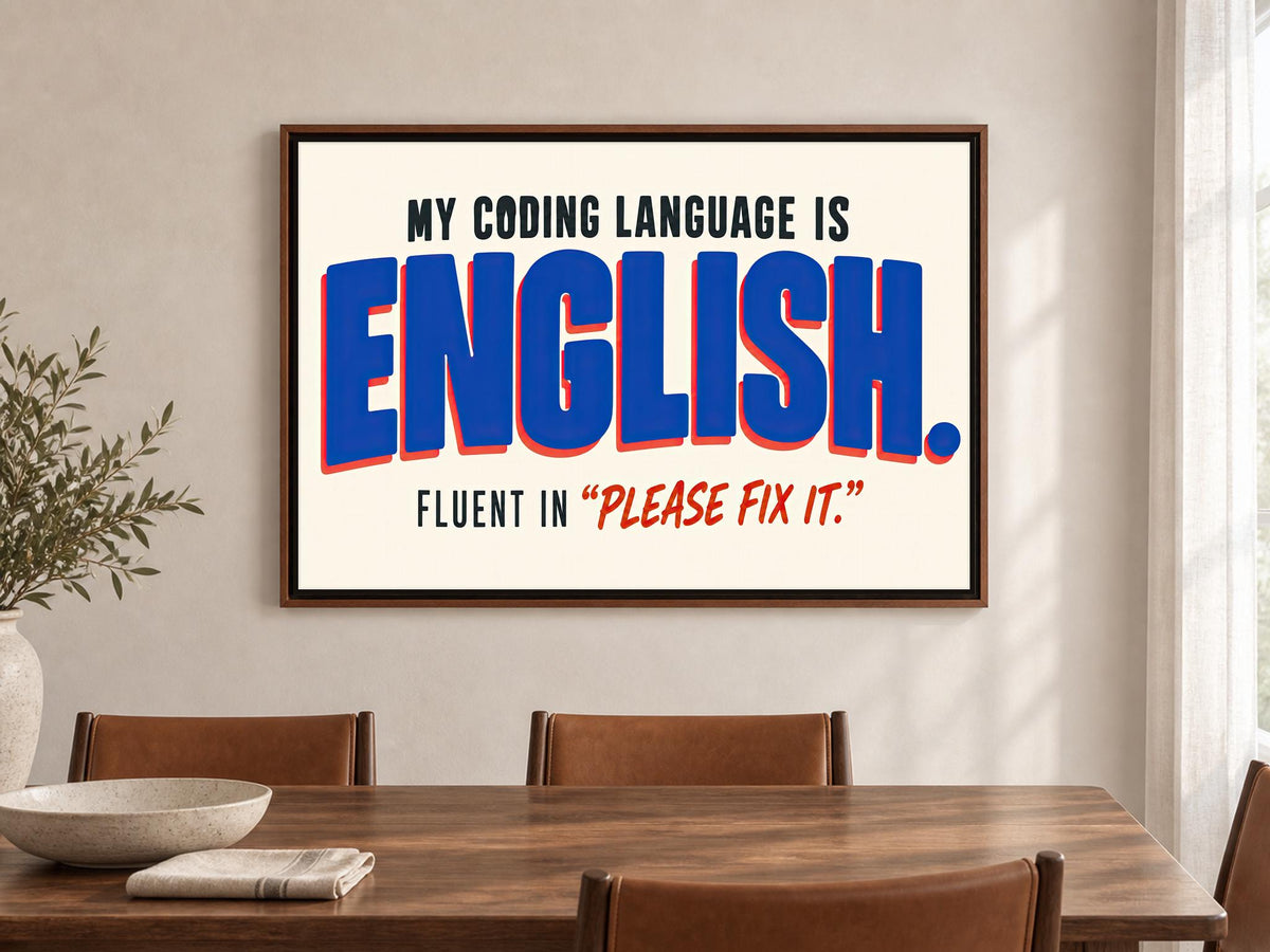 a framed poster with the text "MY CODING LANGUAGE IS ENGLISH. FLUENT IN "PLEASE FIX IT"".