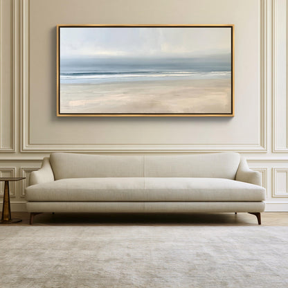Calm minimalist beach canvas wall art, large, framed painting of a beach scene hanging on a wall above a beige sofa in a