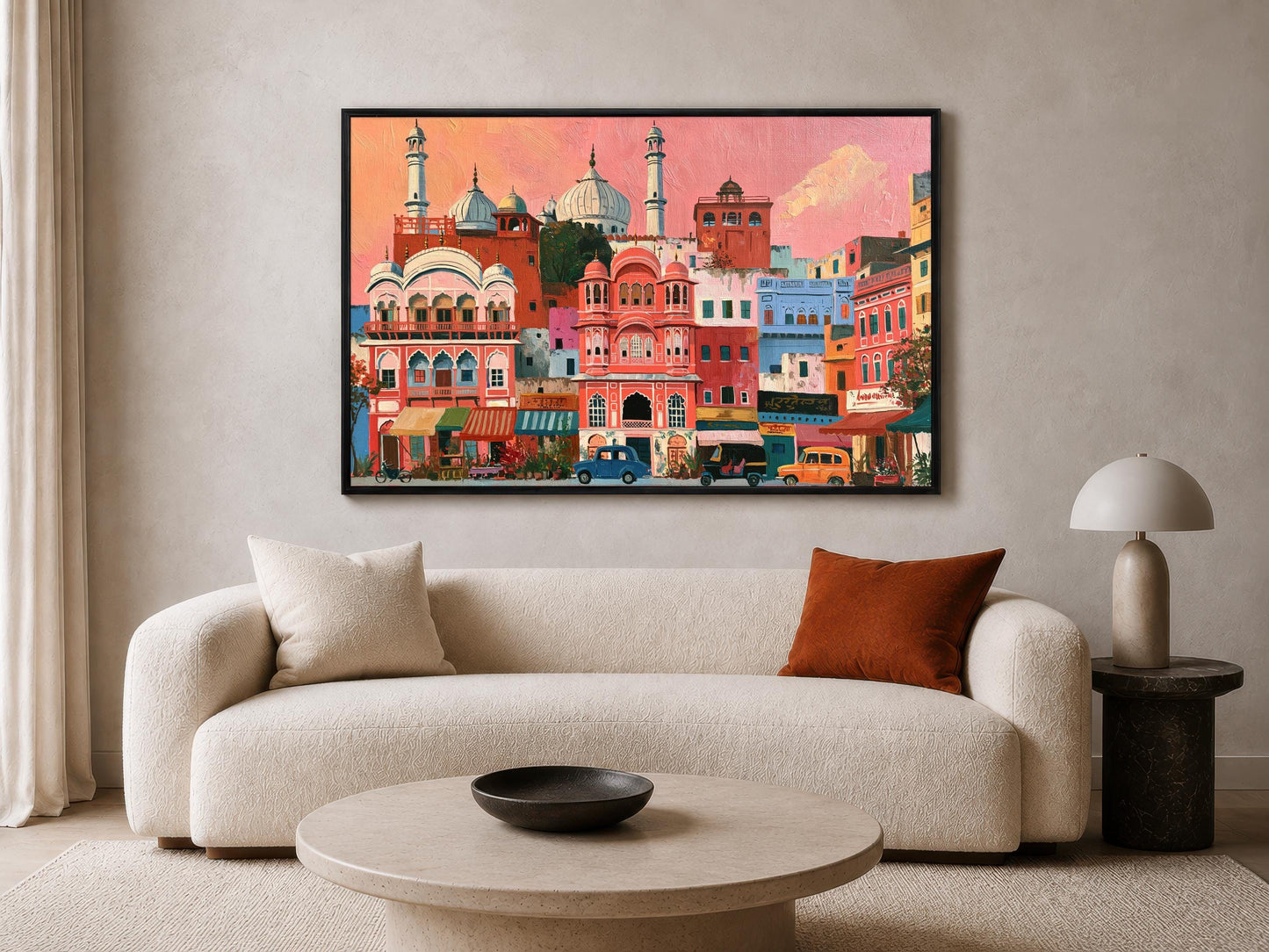 a large, colorful painting of a cityscape hanging on a wall above a white sofa in a living room.