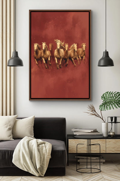 a living room with a black sofa, a coffee table, and a framed artwork of a group of horses running on a red background.
