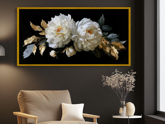 a large framed painting of white peonies with gold leaves hanging on a wall above a beige armchair in a living room setting.